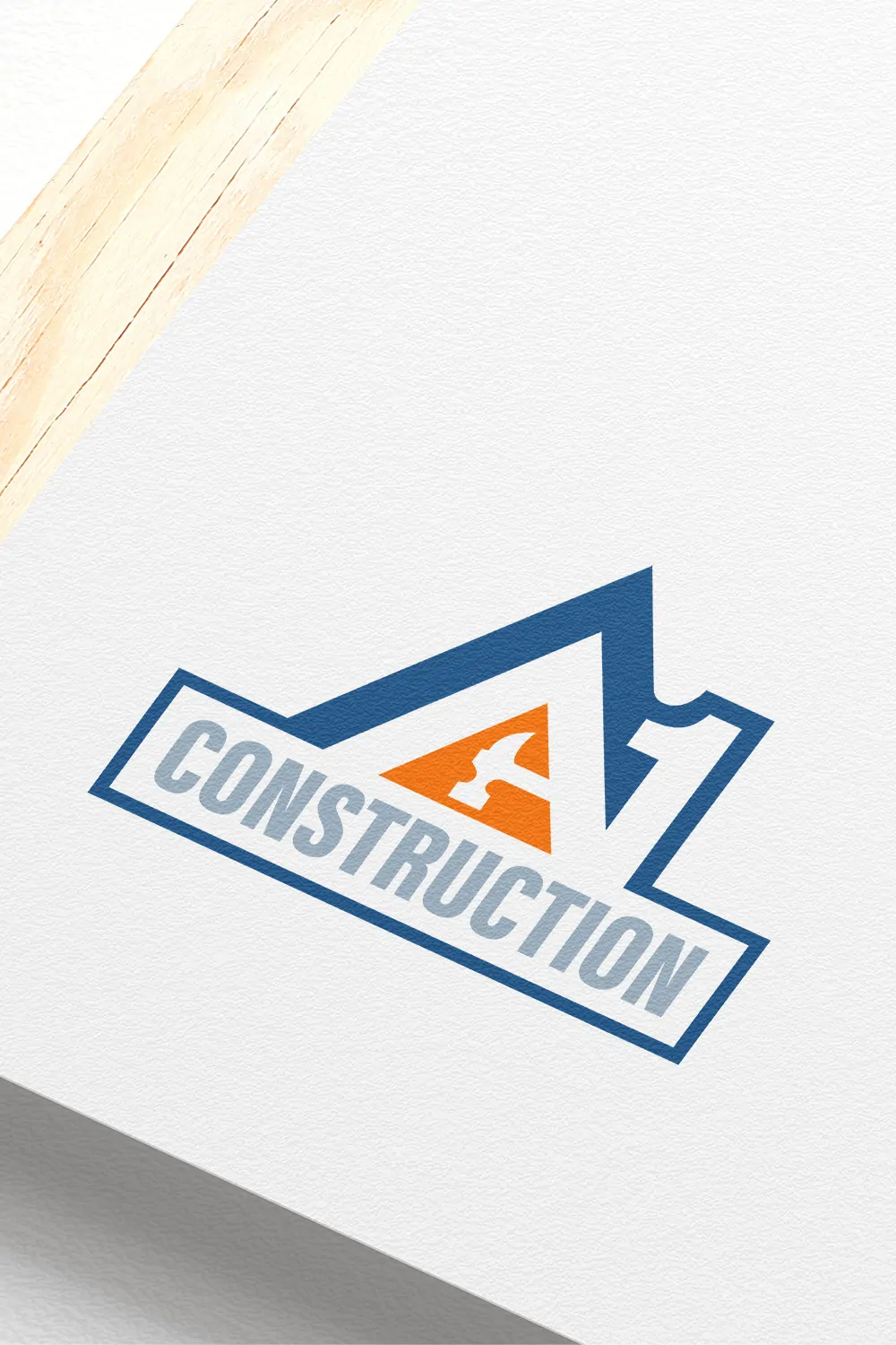 Logo of "a1 construction" featuring a stylized mountain and house silhouette inside a blue angular design, printed on textured white paper with a wooden pencil partially covering the top left corner.